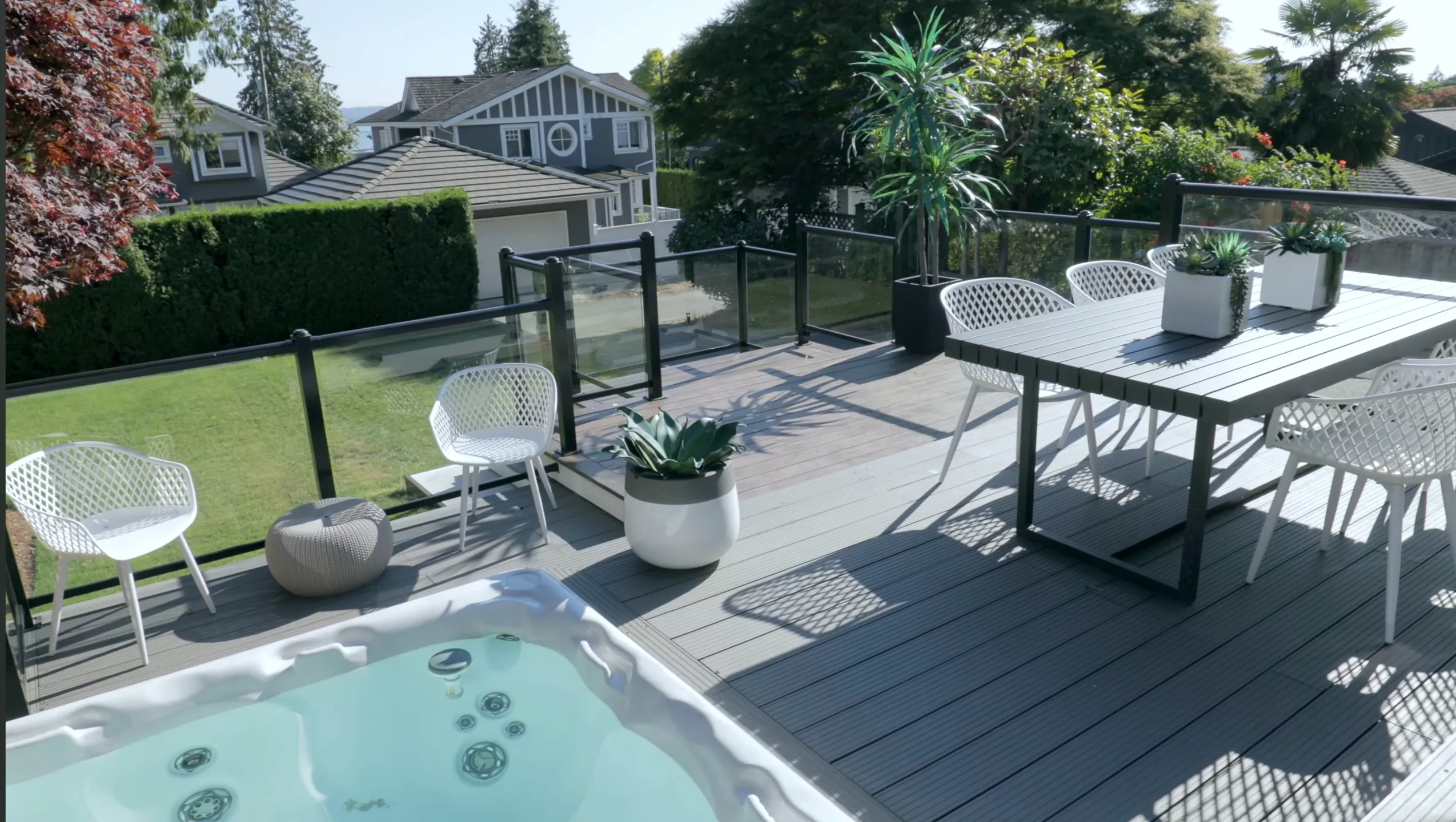 Outdoor deck with hot tub and patio dining at 1276 Haywood Avenue, West Vancouver — remodeled by Jim Lazos of DELANA Interiors