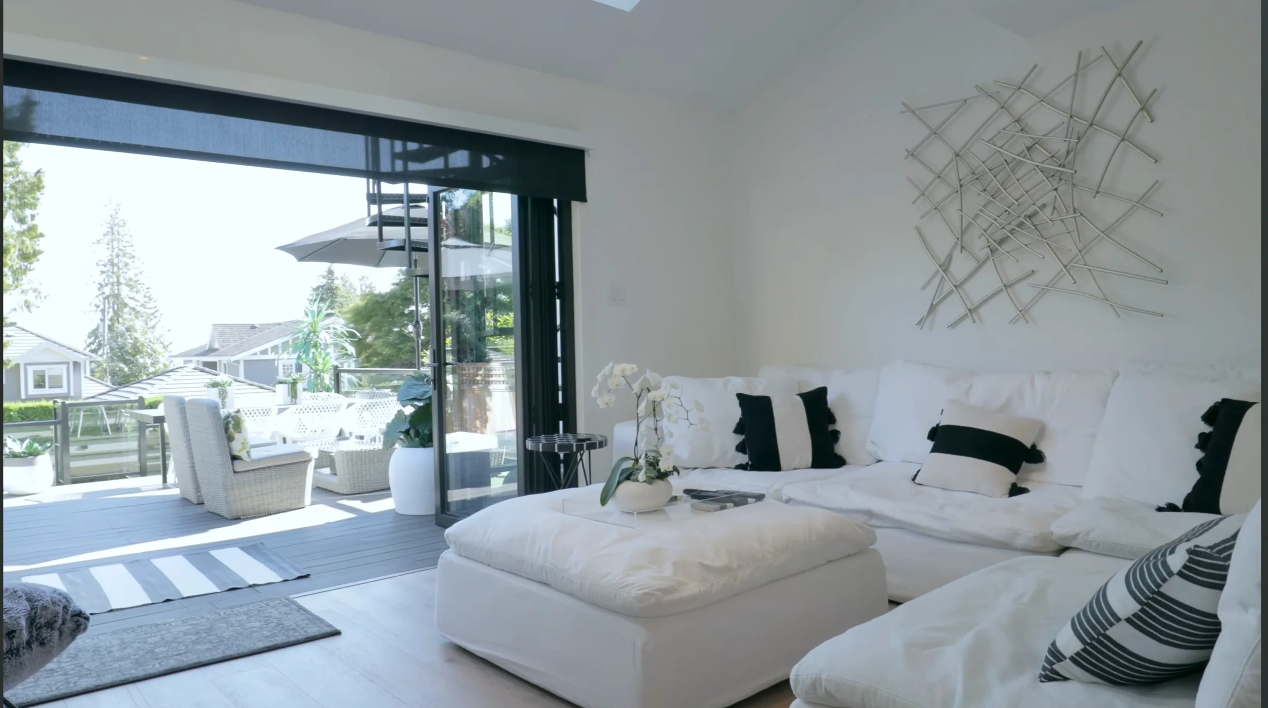 Living room sectional with sliding glass doors to deck at 1276 Haywood Avenue, West Vancouver — remodeled by Jim Lazos of DELANA Interiors