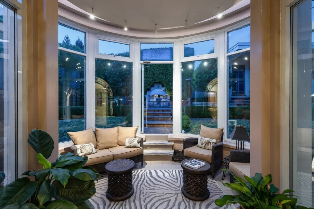 Curved glass conservatory sunroom inside the 1561 Inglewood custom home, West Vancouver — DELANA Interiors