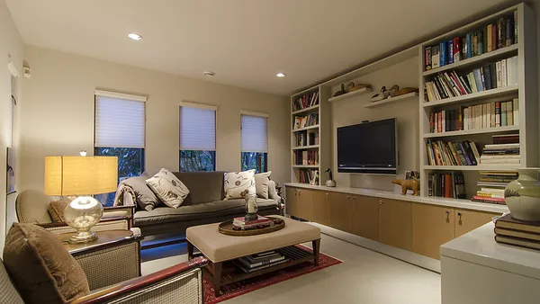 Library and family room with built-in bookshelves at 1561 Inglewood Avenue, West Vancouver — DELANA Interiors