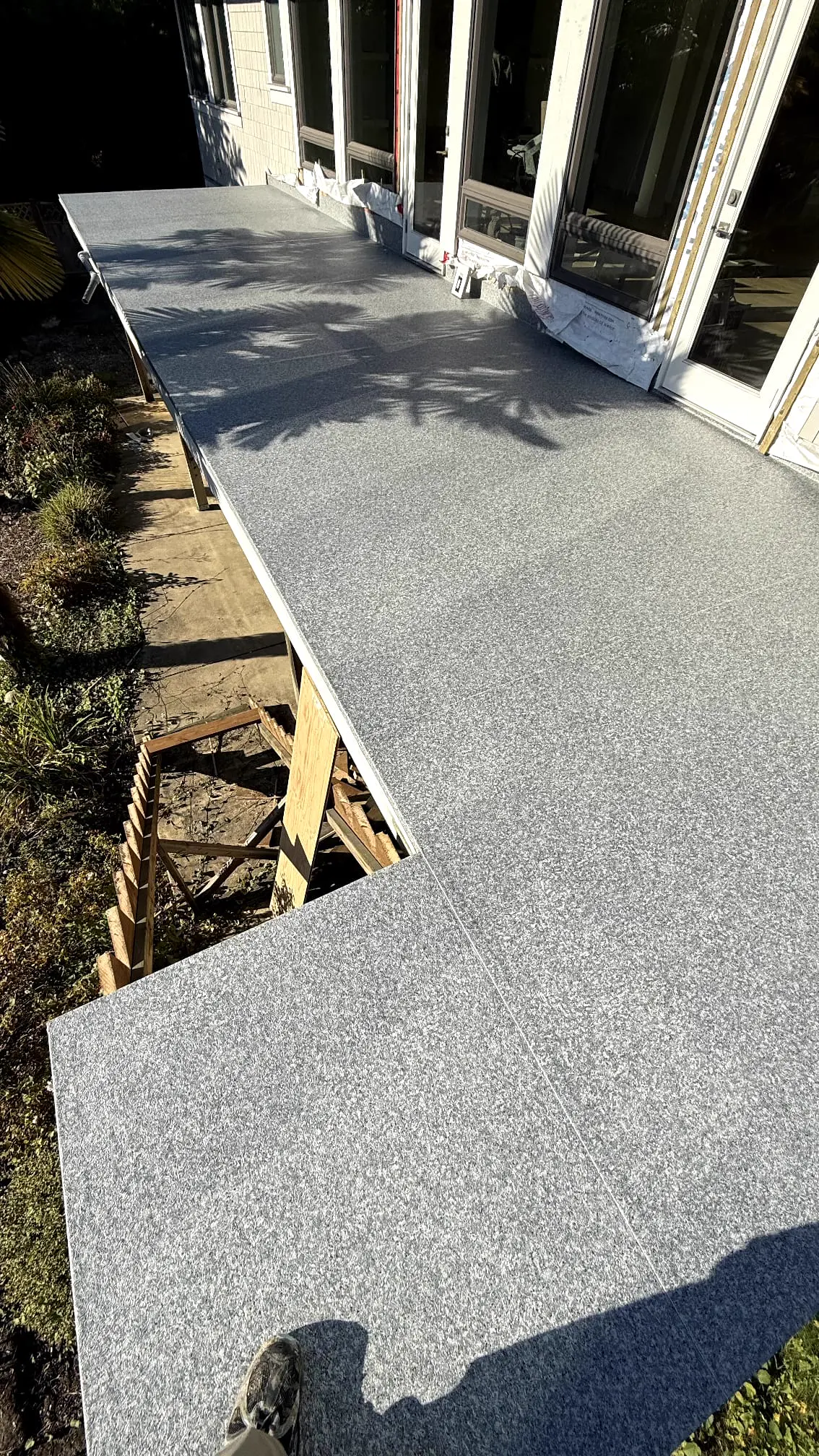 New deck surface being installed during the 1220 Ottaburn Road home renovation in West Vancouver by DELANA Interiors
