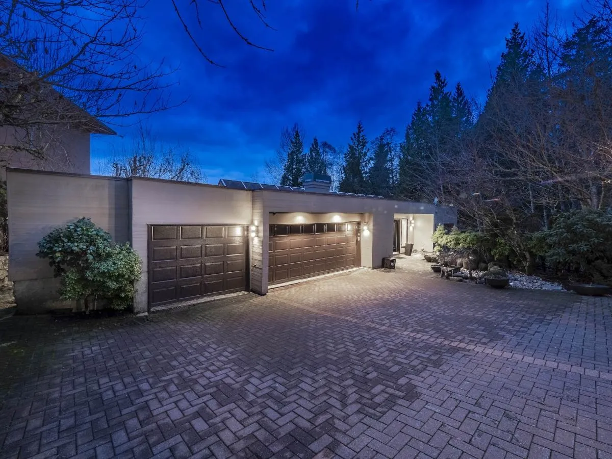 Renovated home exterior at dusk — 1588 Pinecrest Drive, Canterbury, West Vancouver — by Jim Lazos of DELANA Interiors