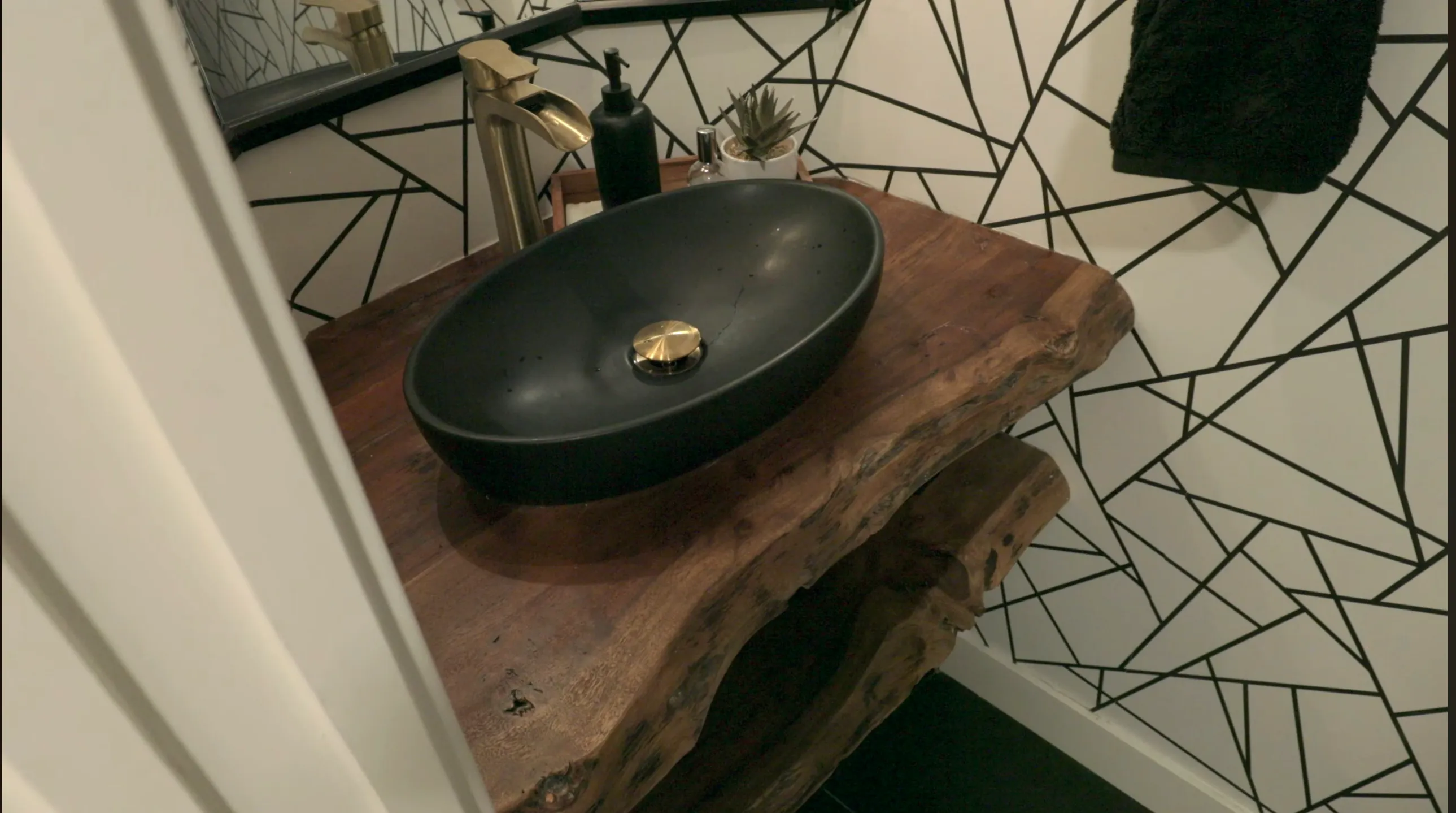 Powder bath with black vessel sink and brass fixtures — 1588 Pinecrest Drive West Vancouver renovation by DELANA Interiors