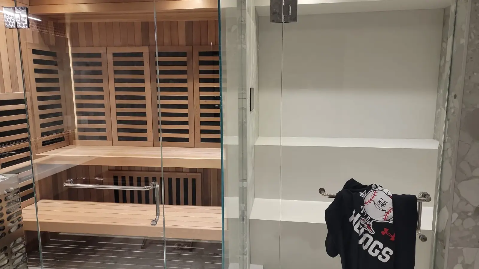 Cedar infrared sauna with full glass door and built-in cedar bench — custom spa bathroom renovation Vancouver