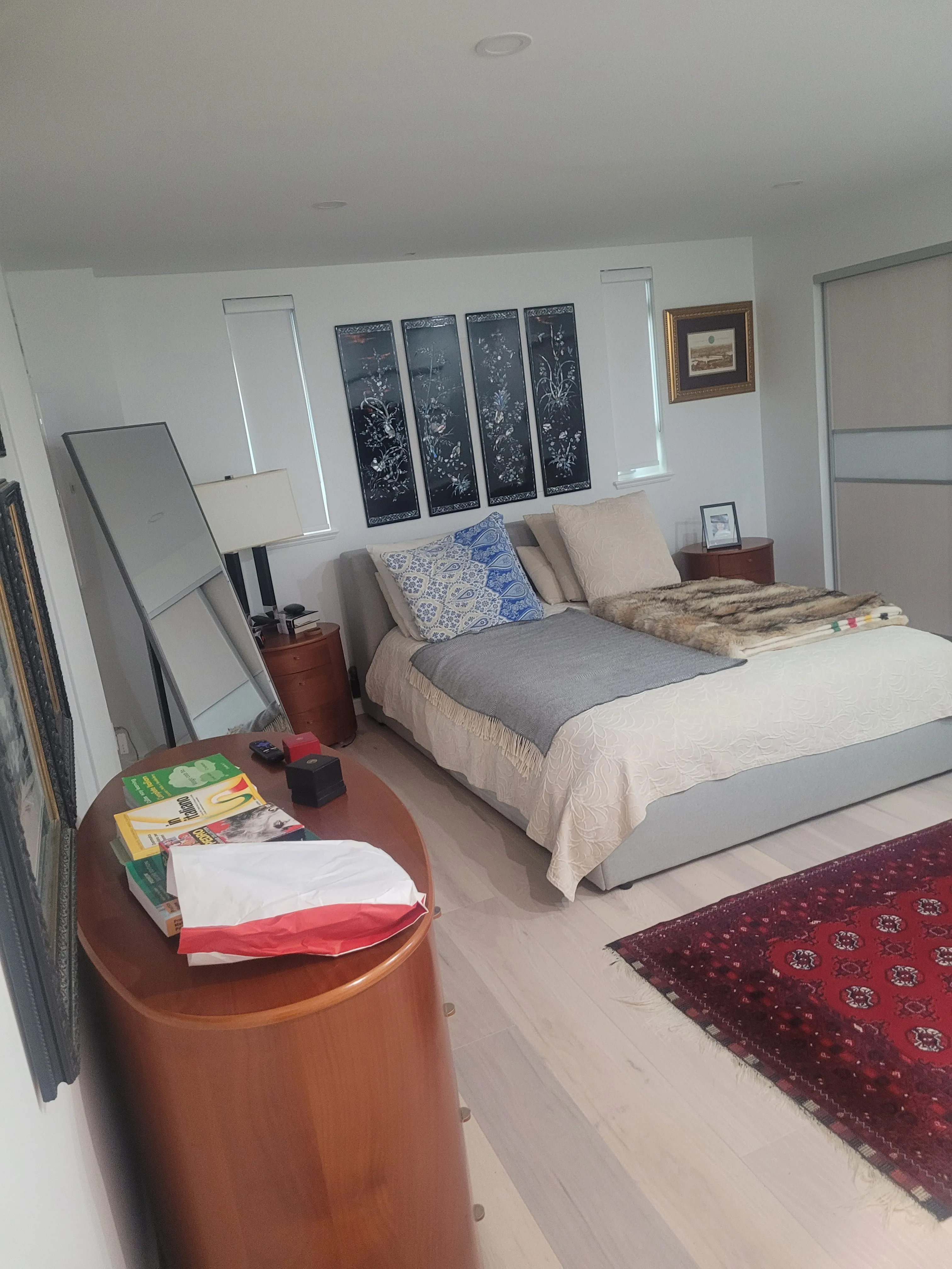 Renovated basement bedroom with custom built-in wardrobe — West Vancouver project by DELANA Interiors